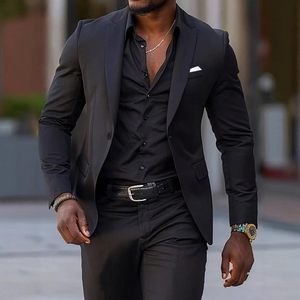 Man wearing a black suit with a blurred background