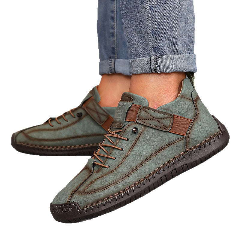 Green casual shoes with brown accents worn with rolled-up jeans on a white background