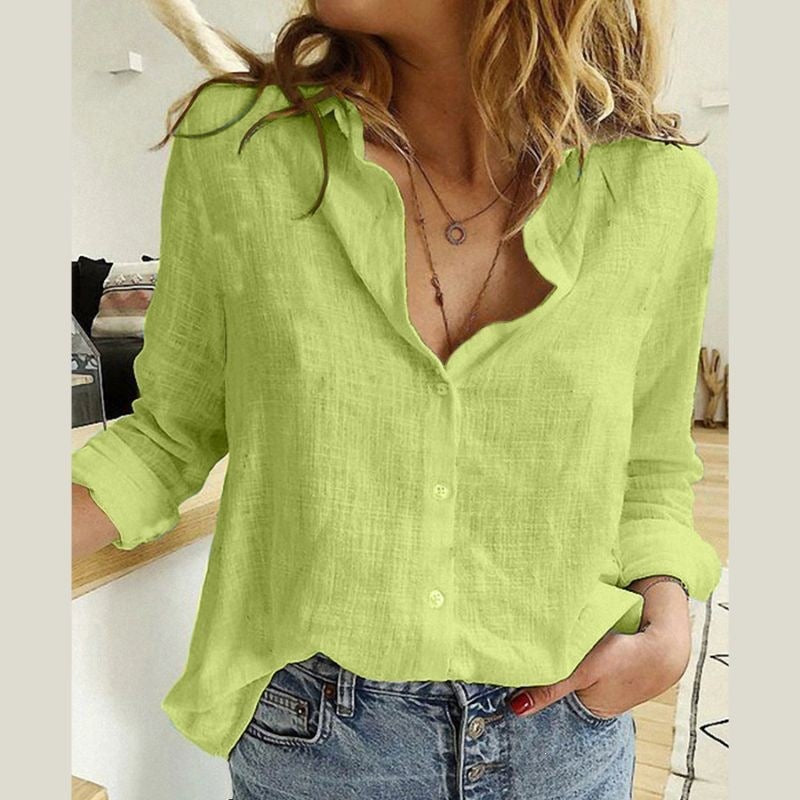 Person wearing a bright green shirt and blue jeans indoors.