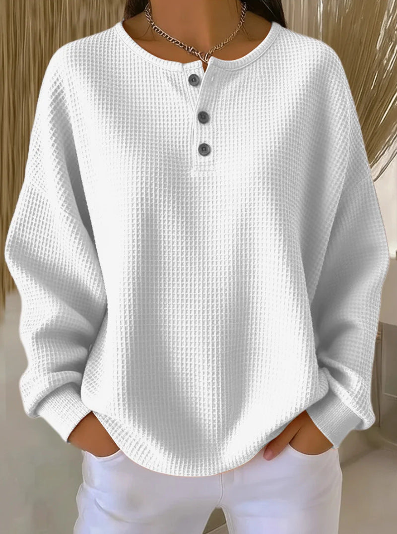 White textured long-sleeve top worn by a person with a neutral background