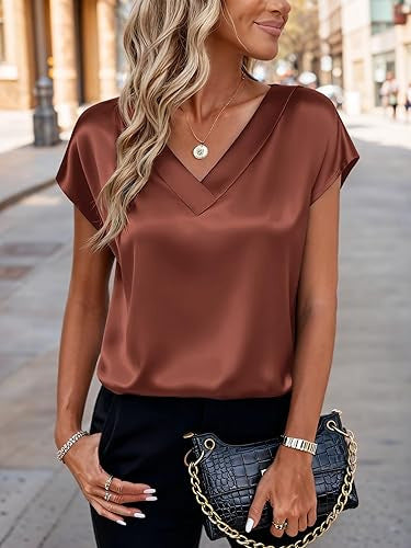 Woman wearing a brown satin top with a blurred street background