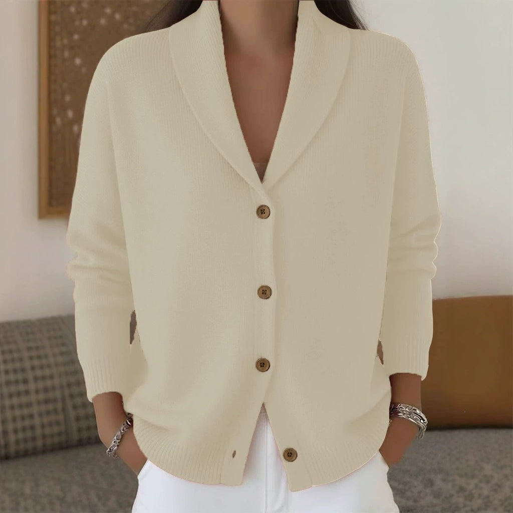 Beige cardigan worn by a person with a blurred background
