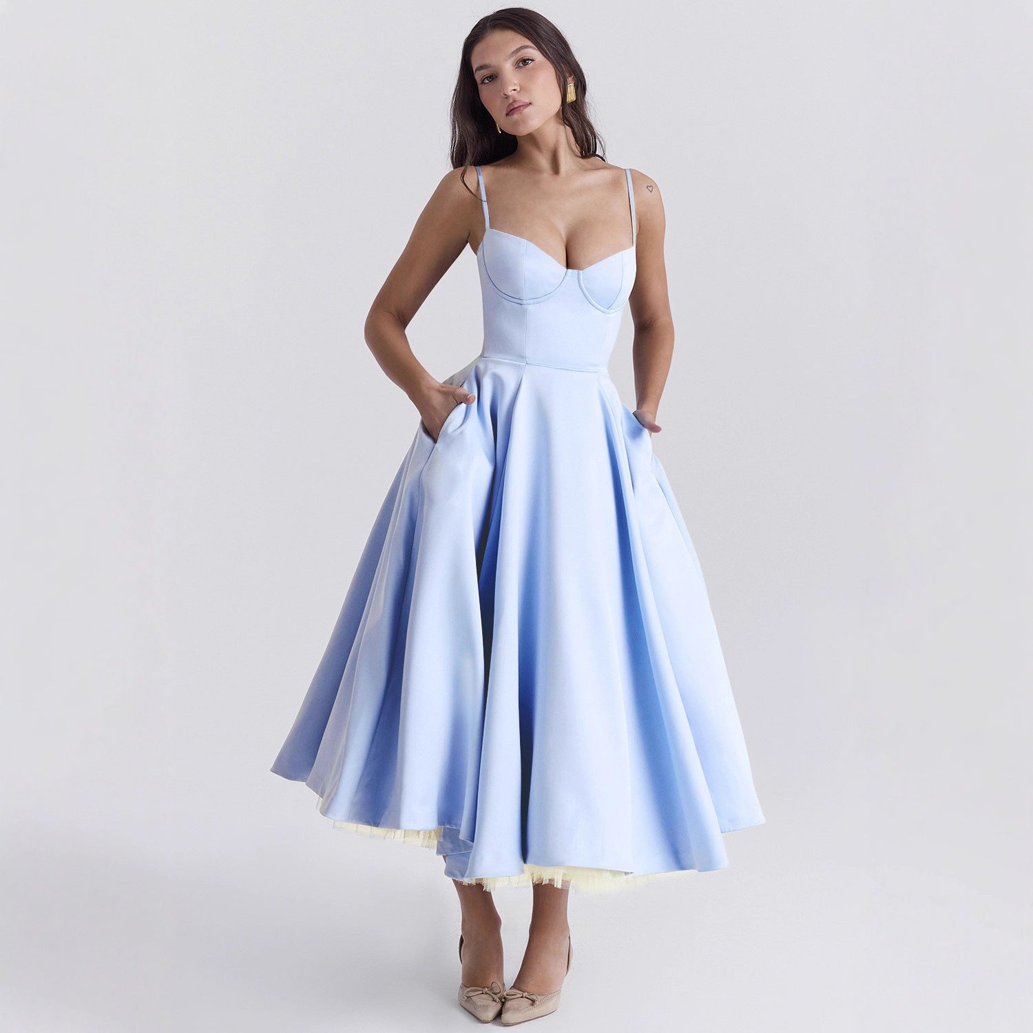 Woman wearing a light blue dress on a white background