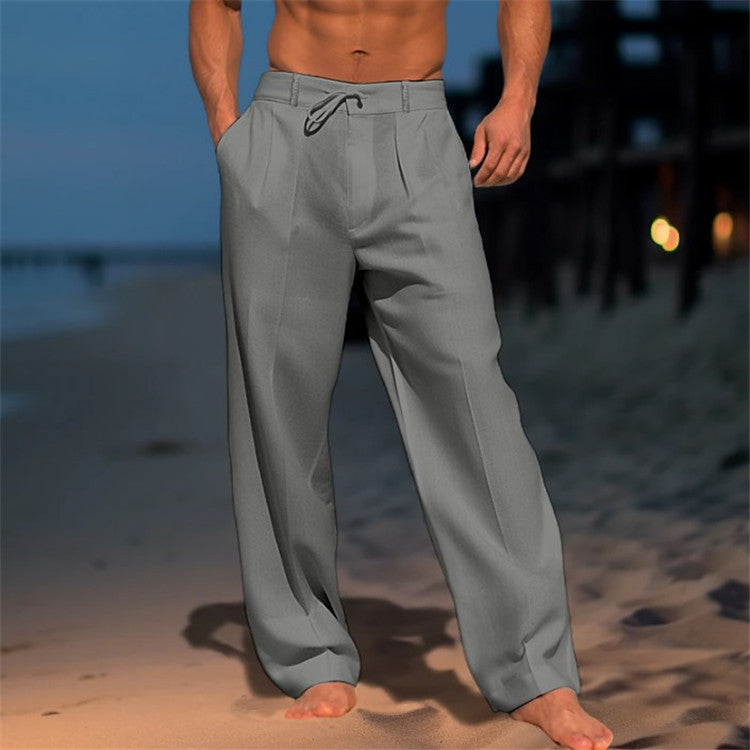 Person wearing gray pants on a beach at dusk