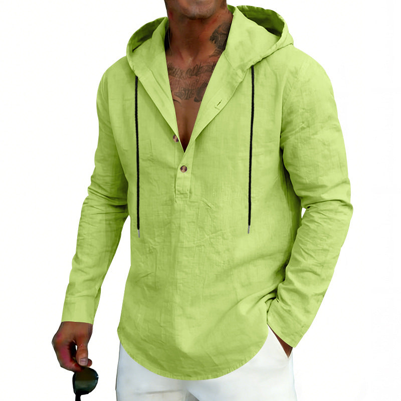 Man wearing a light green hoodie with black accents on a white background