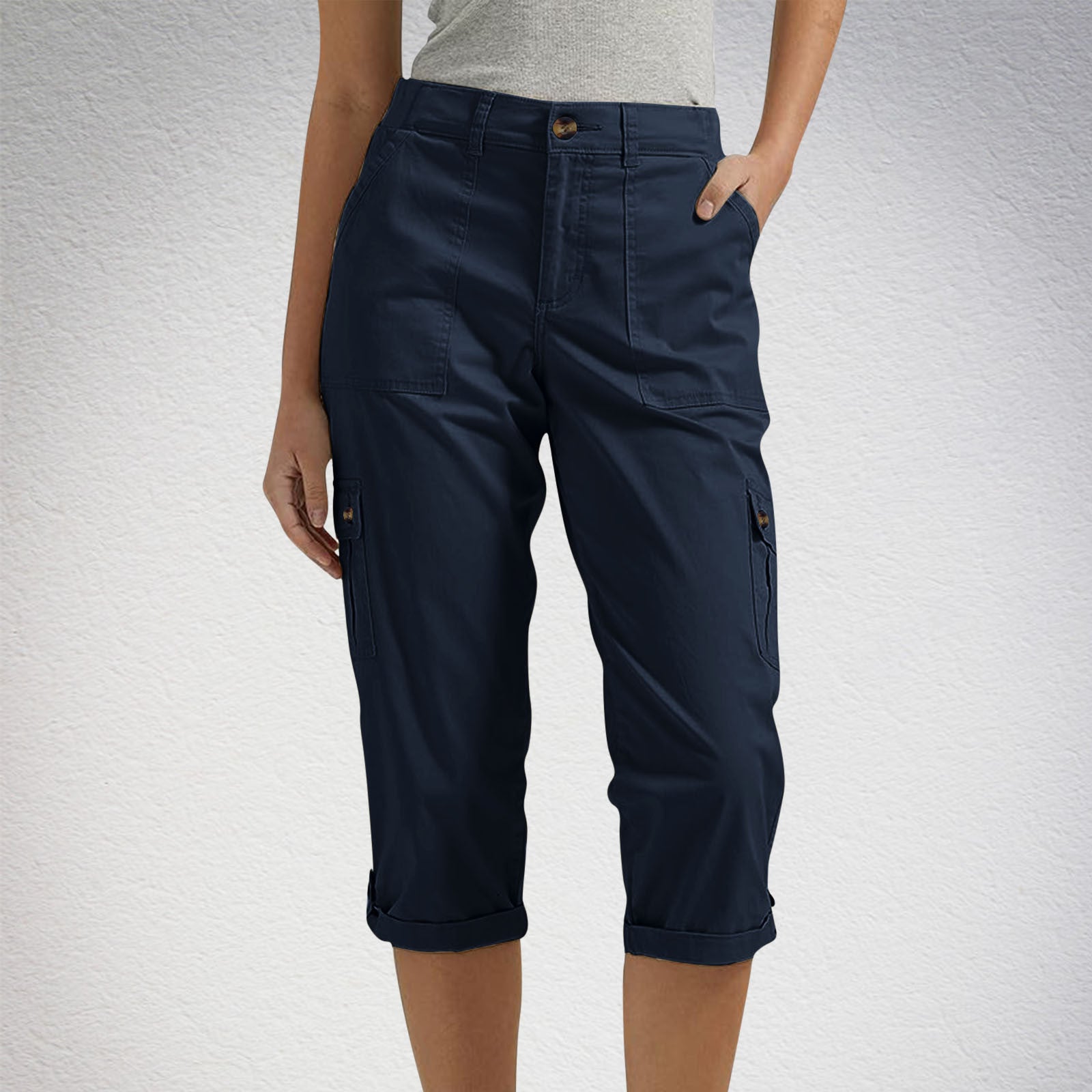 Navy blue capri pants worn by a person on a light gray background