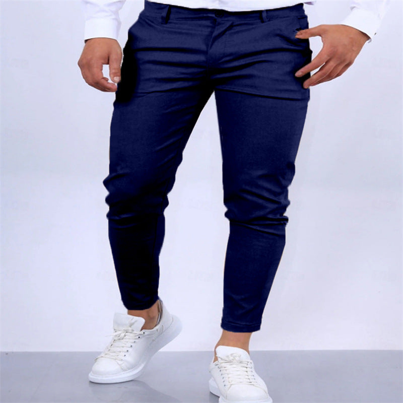 Navy blue pants worn by a person on a white background