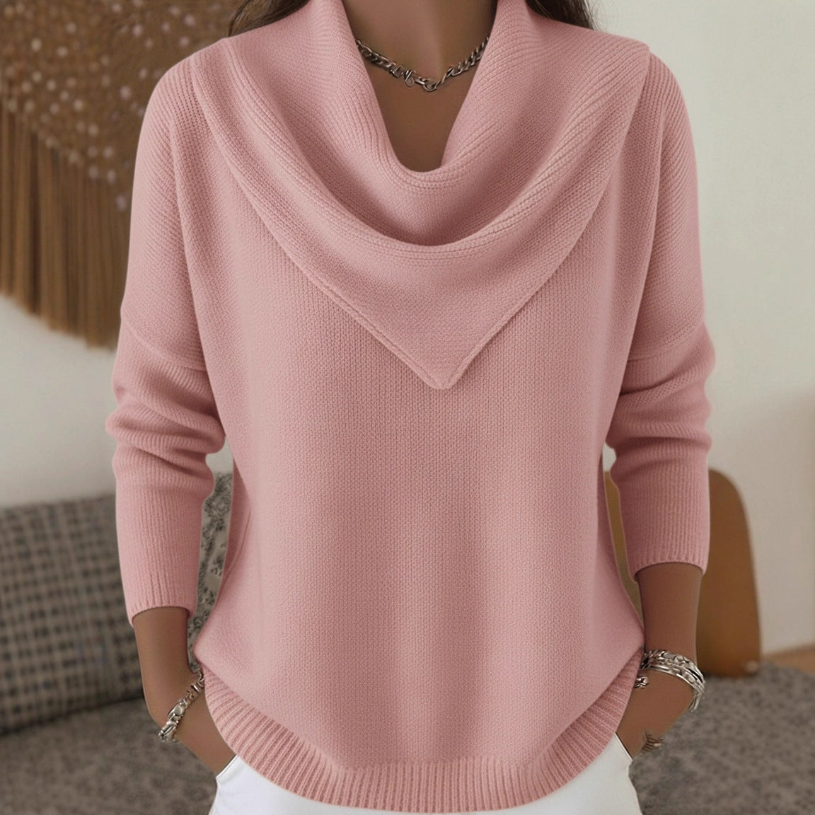 Pink sweater worn by a person in an indoor setting