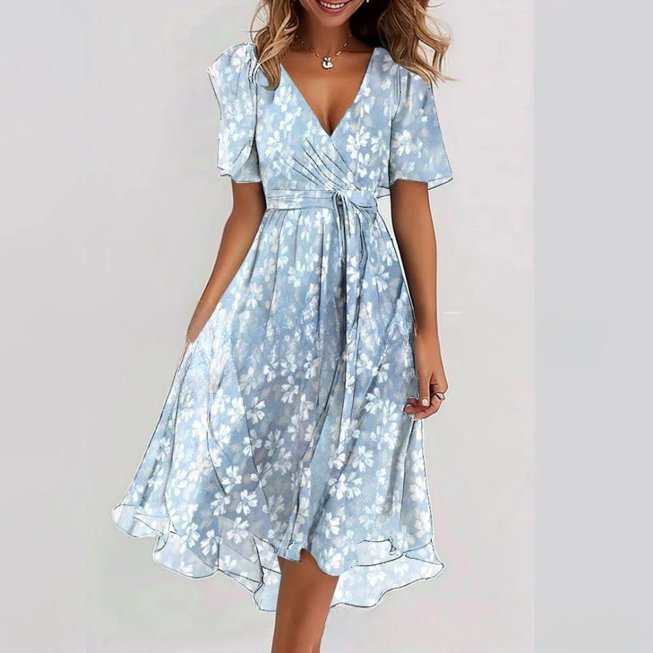 Woman wearing a light blue floral dress on a plain background