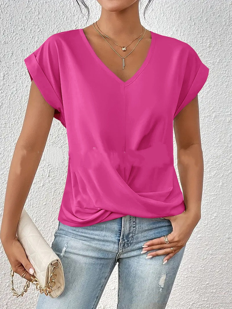 Person wearing a bright pink top and blue jeans against a white background