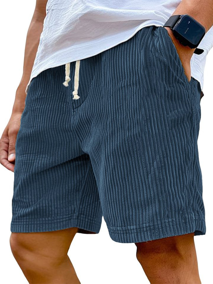 Person wearing blue shorts with a white background