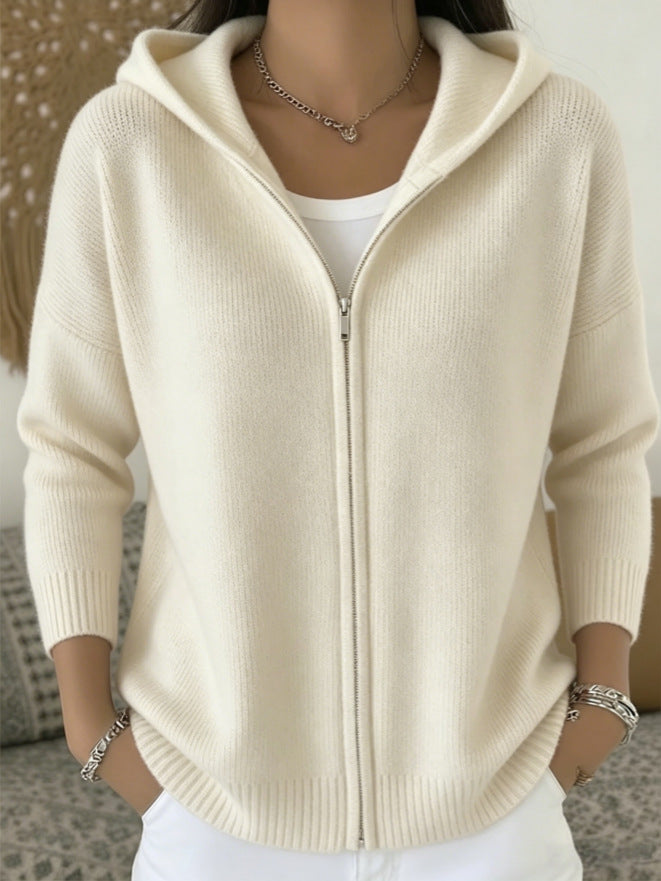 Beige hoodie worn by a person with a neutral background