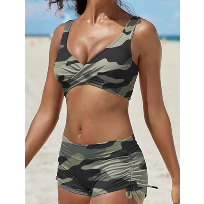 Person wearing a camouflage bikini set on a beach