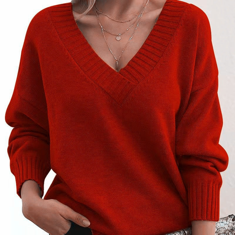 Red sweater worn by a person on a white background