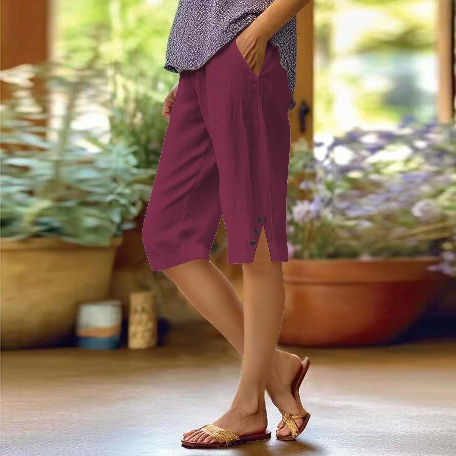 Person wearing purple shorts standing in a garden with plants and flowers in the background