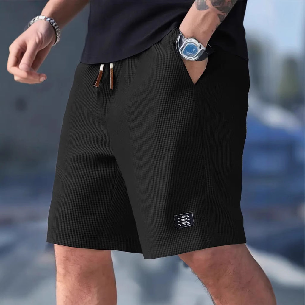 Person wearing black shorts with a blurred background