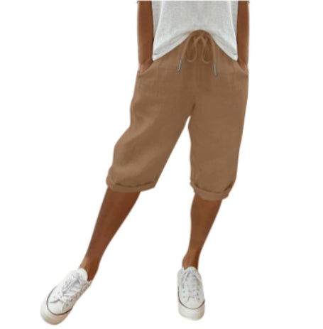 Brown capri pants worn by a person on a white background