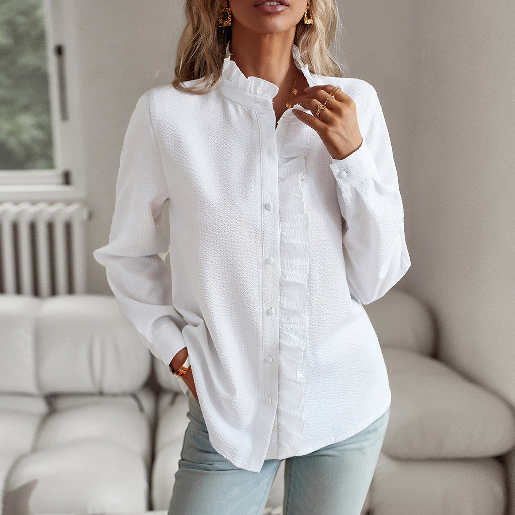 Woman wearing a white button-up shirt in a living room setting