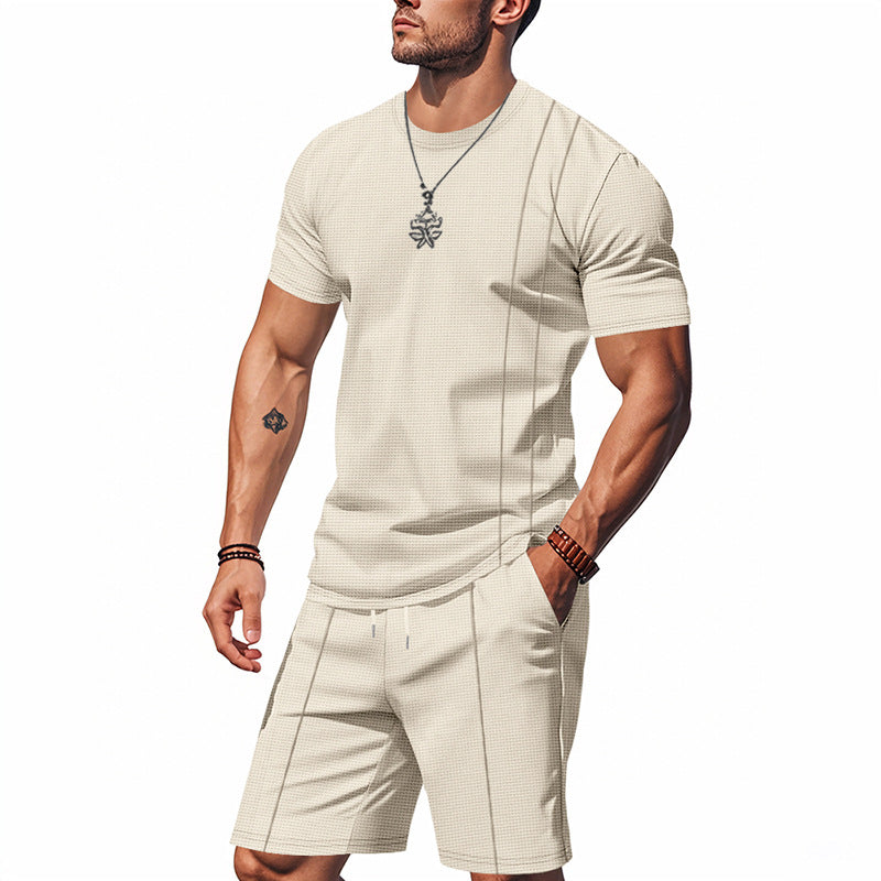 Man wearing a beige t-shirt and shorts set on a white background