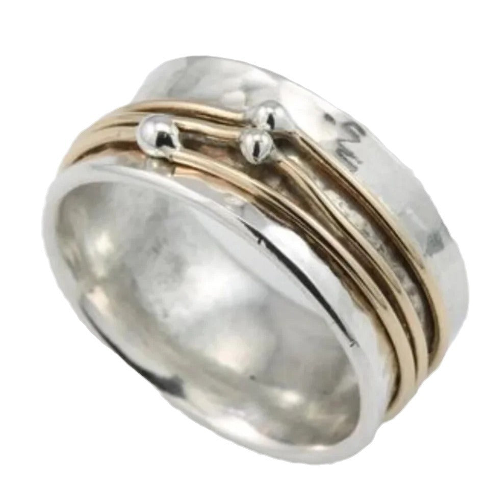 Silver and gold ring on a white background