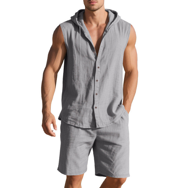 Man wearing a gray sleeveless shirt with a hood and shorts on a white background