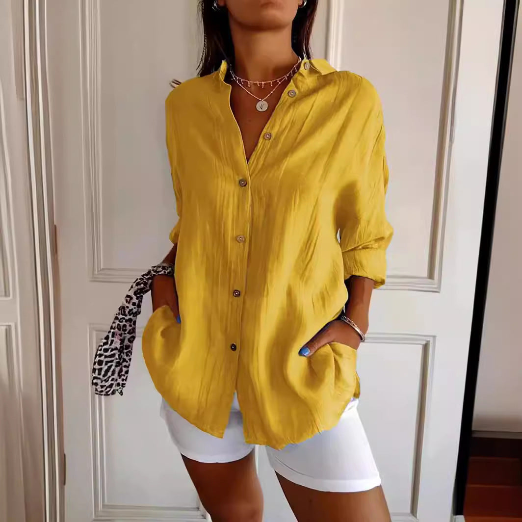 Person wearing a yellow shirt and white shorts in front of a white door.