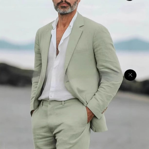Man wearing a light green suit with a blurred background
