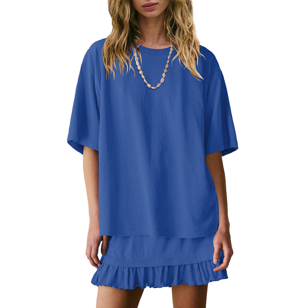 Blue dress with ruffled hem worn by a model on a white background