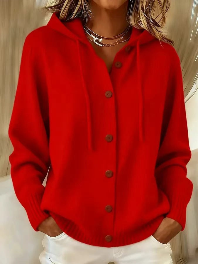 Red cardigan worn by a person with 'NatureQueens' branding.