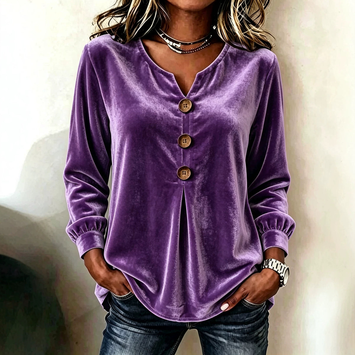 Purple velvet button-up shirt worn by a person against a neutral background