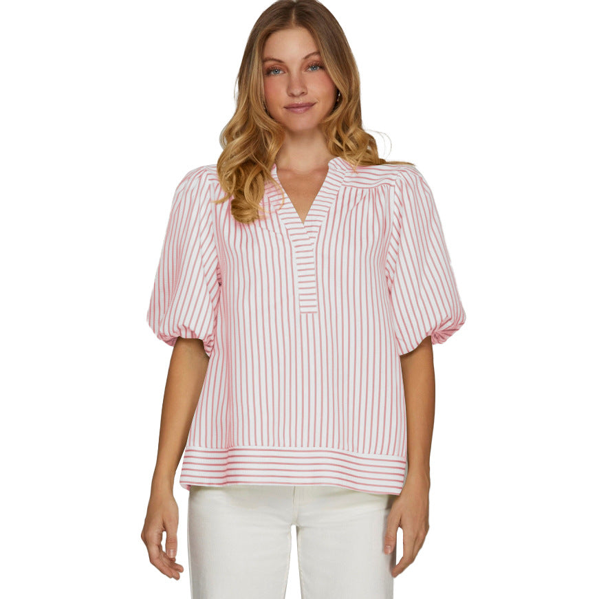 Woman wearing a pink and white striped blouse on a white background