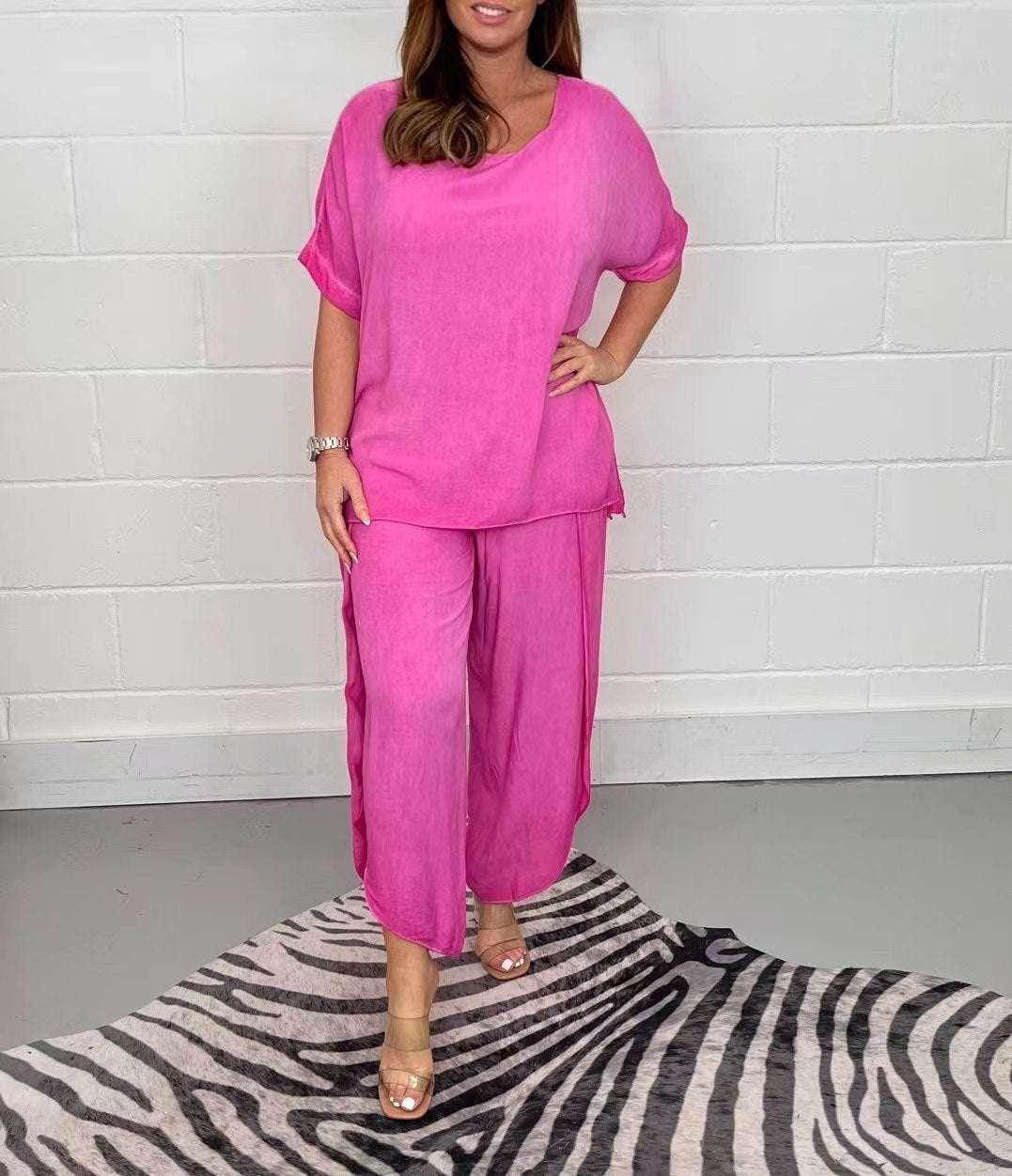 Woman modeling loose pink loungewear set from ZA-Zola, standing on zebra print rug