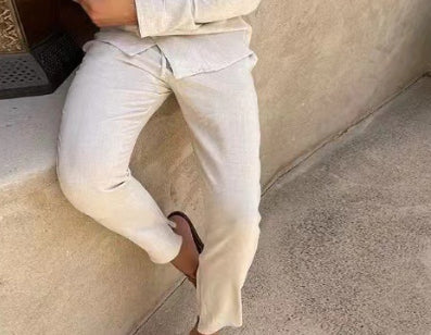 Person wearing light-colored pants sitting on a step.
