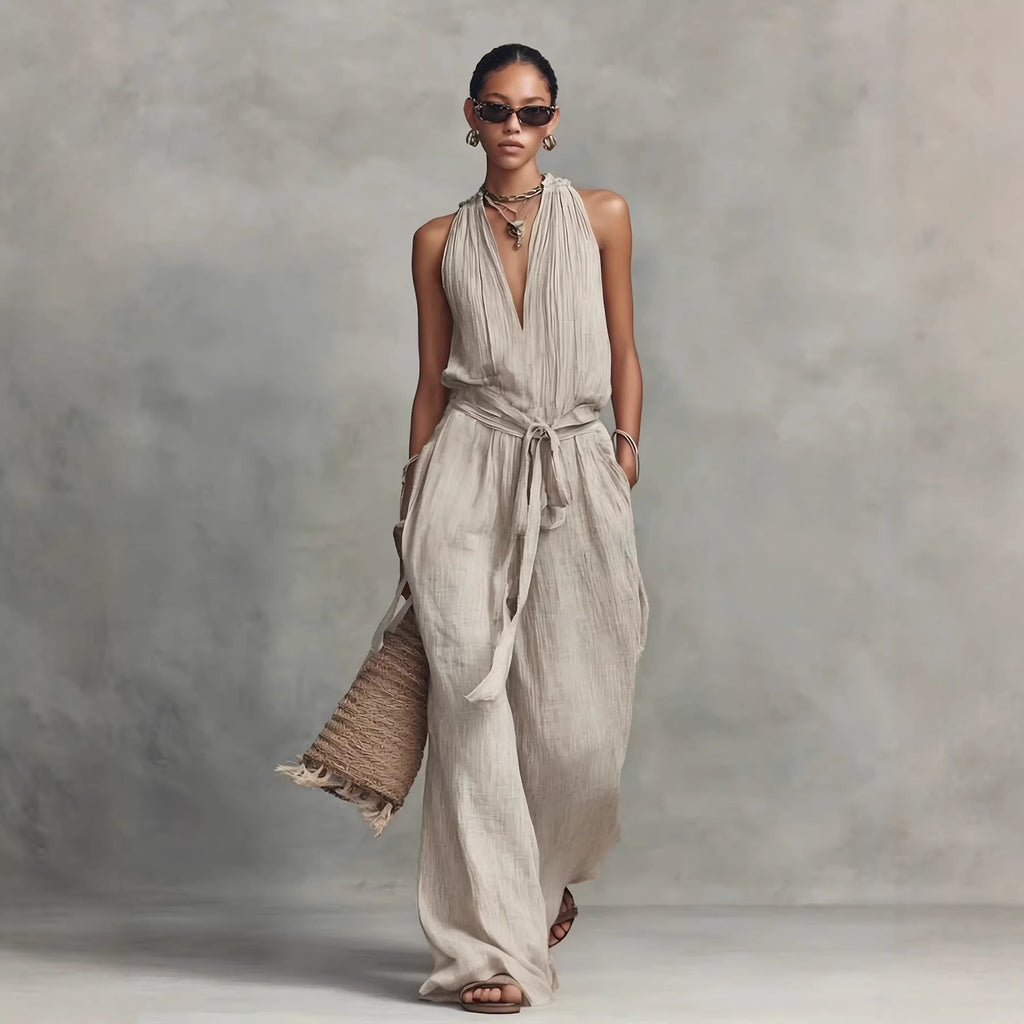 Woman wearing a flowing beige dress against a neutral background