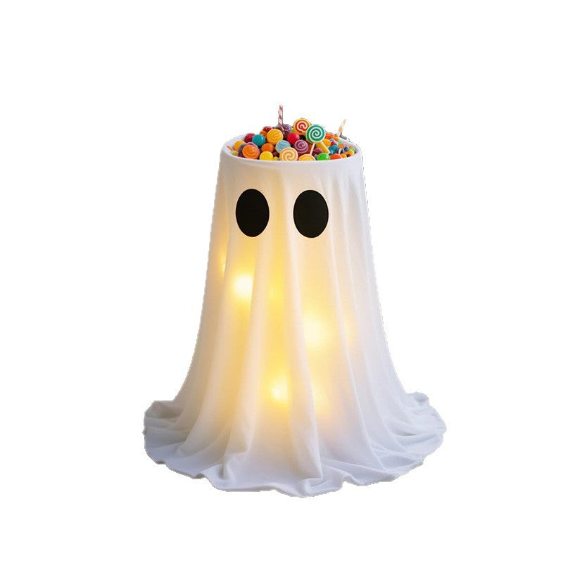 Ghost-shaped container with candy on a white background