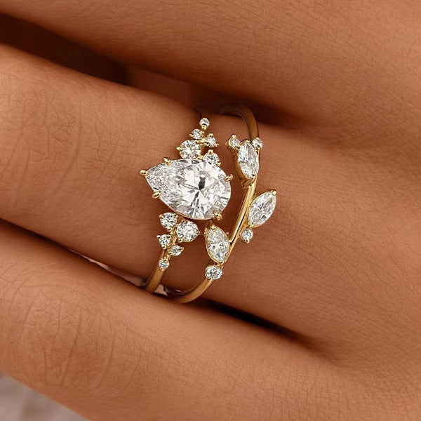 Gold ring with diamond accents on a person's finger against a brown background