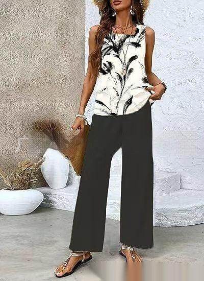 Woman wearing black wide-leg pants and a sleeveless floral top, ZA-Zola UK chic fashion