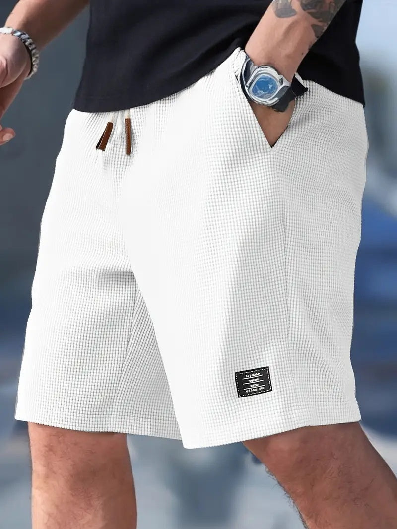 White checkered shorts worn by a person with a blurred background