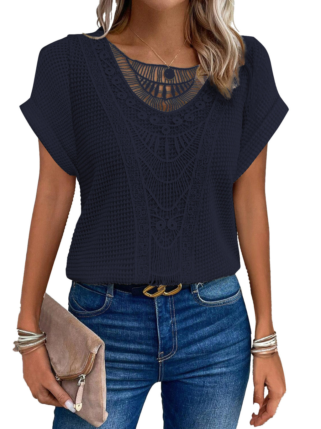 Navy blue top with lace detail worn by a person, paired with blue jeans.