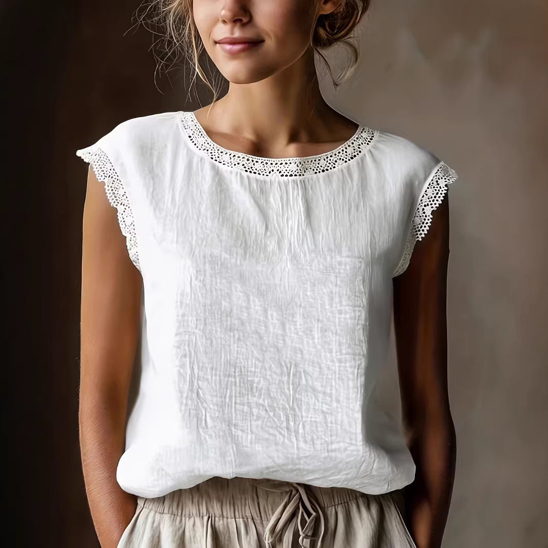 Woman wearing a white sleeveless top with lace details against a neutral background
