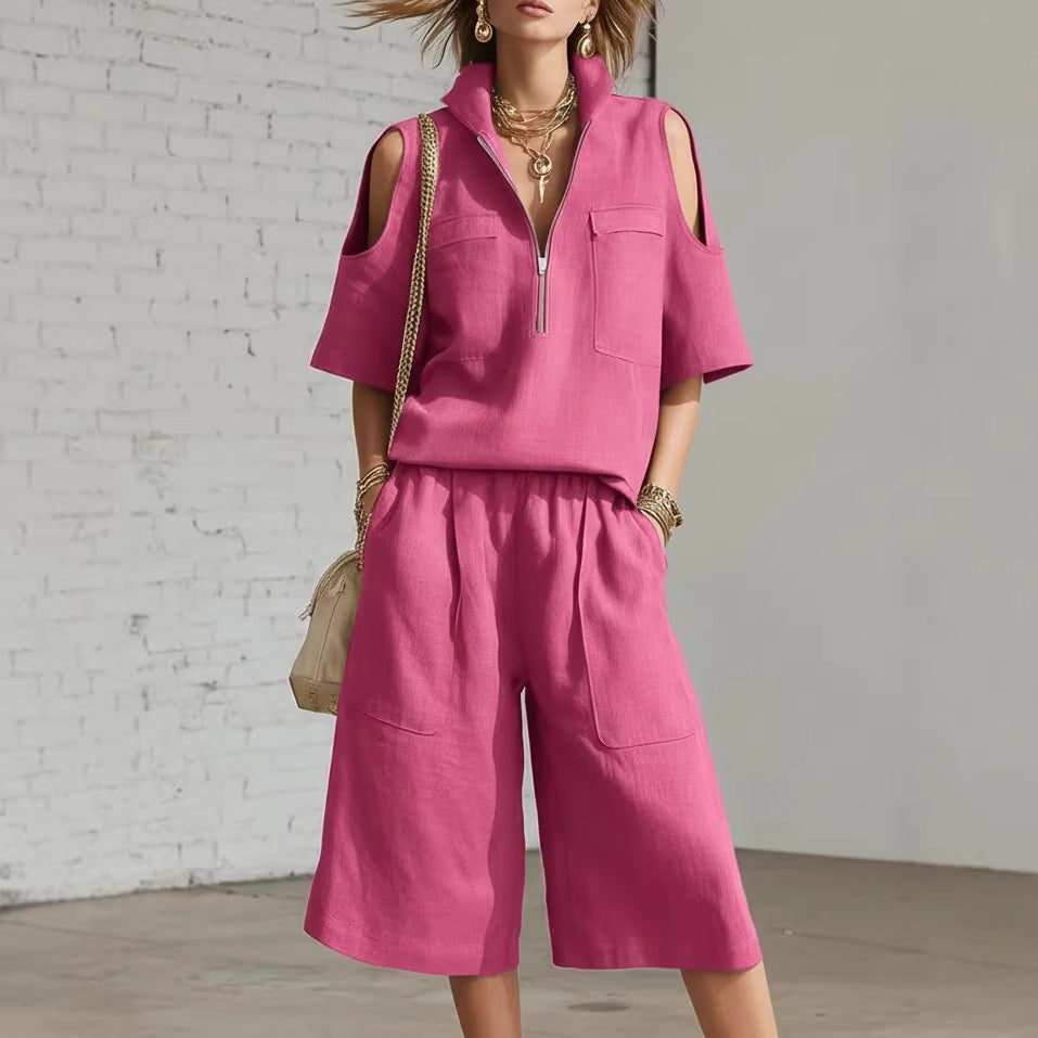 Person wearing a pink outfit with a white brick wall background