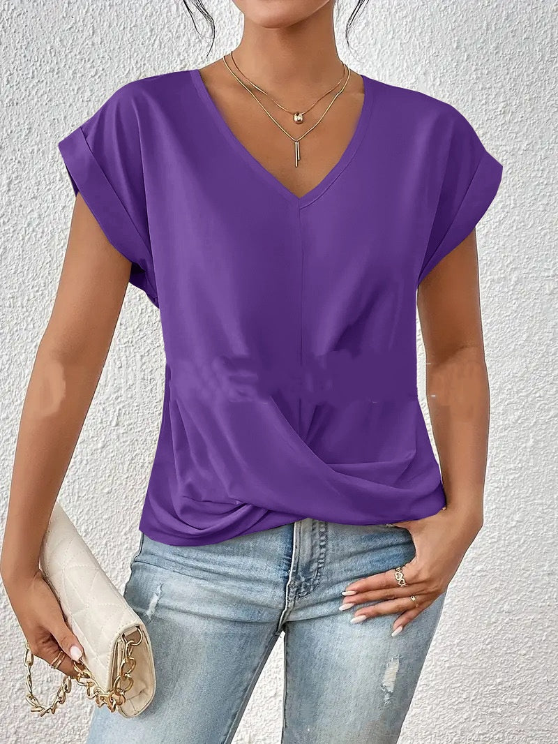Person wearing a purple top and blue jeans against a white background