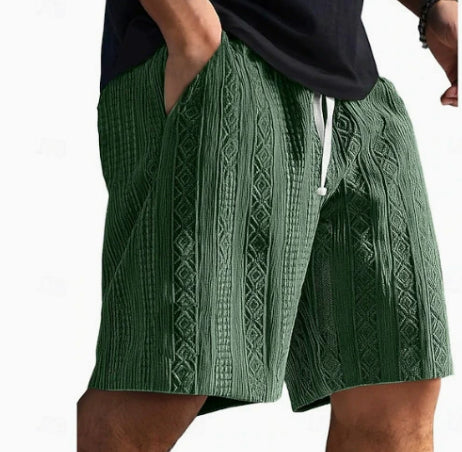 Green patterned shorts worn by a person on a white background