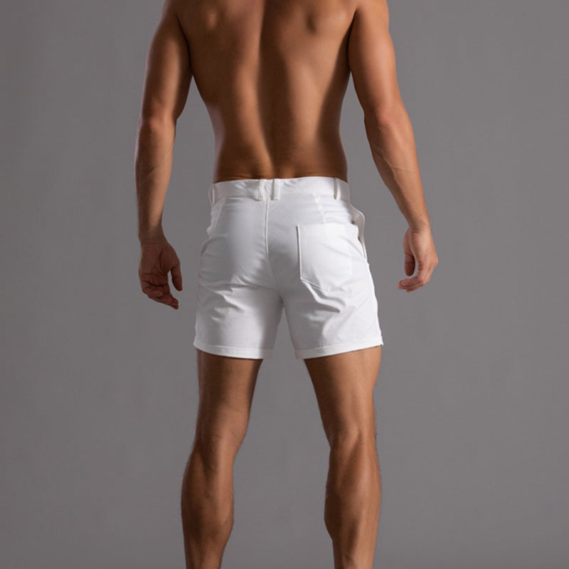 Man wearing white shorts against a gray background