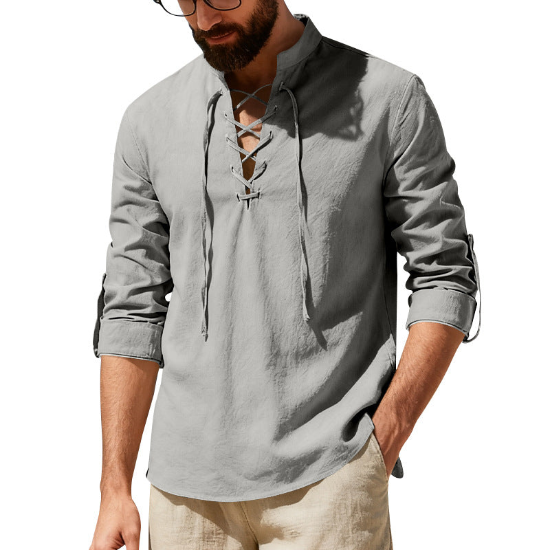 Man wearing a gray long-sleeve shirt with a white background