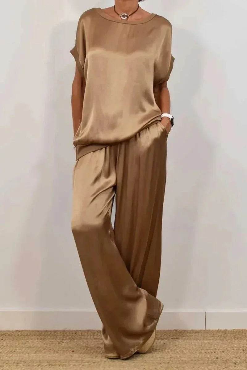 Woman wearing a loose, gold satin top and wide-leg trousers from ZA-Zola fashion UK