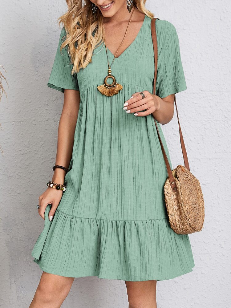 Woman wearing a green dress with a white background