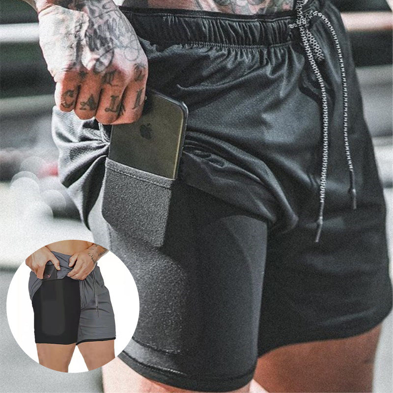 Black athletic shorts with a side pocket holding a smartphone, shown on a person in a gym setting. A circular inset at the lower left shows the shorts without the phone inserted.
