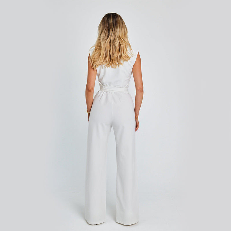 Woman wearing a white jumpsuit on a plain background