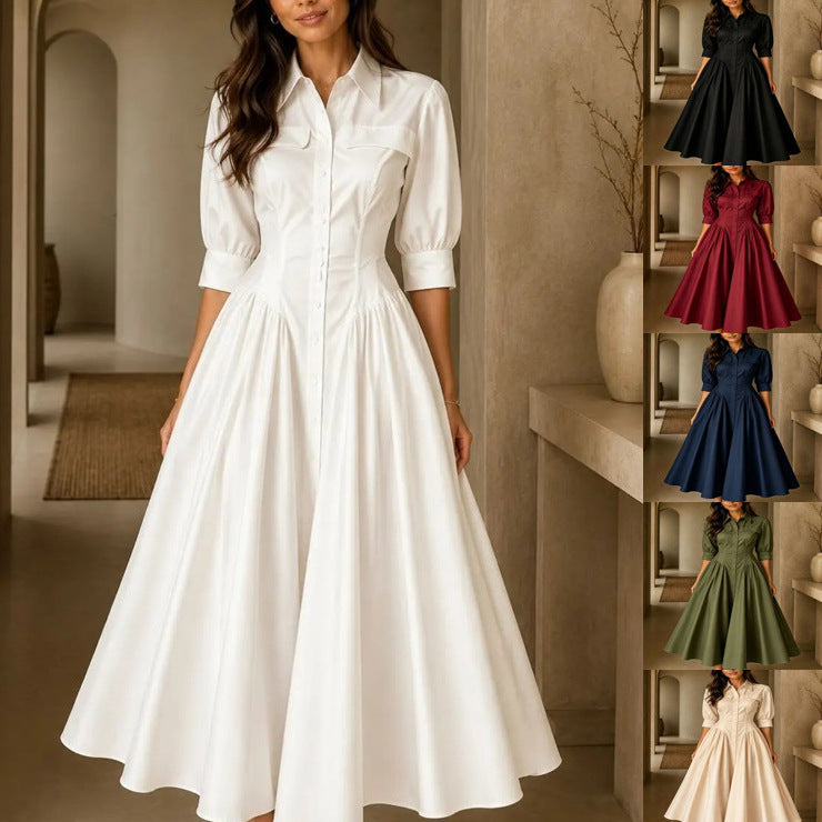 Woman wearing a white dress in an indoor setting with shelves displaying other dresses.